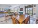 Dining room featuring a wooden table, a ceiling fan, and seamless access to both the living area and outdoor spaces at 6216 Kevesta Ave, Palmetto, FL 34221