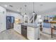 Modern kitchen with stainless steel appliances, granite countertops, and island seating open to the living spaces at 6216 Kevesta Ave, Palmetto, FL 34221