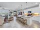 Open-concept kitchen with a large island, stainless steel appliances, and seamless flow into the dining and living areas at 6216 Kevesta Ave, Palmetto, FL 34221