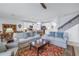 Inviting living room with neutral sofas, a cozy rug, open to a kitchen, and a staircase at 6216 Kevesta Ave, Palmetto, FL 34221