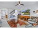 Bright living room featuring tile floors, comfy sofas, TV, and an open staircase, perfect for entertaining at 6216 Kevesta Ave, Palmetto, FL 34221