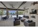 Outdoor lounge area with comfortable seating, ceiling fans, a fireplace, and a view of the community pool at 6216 Kevesta Ave, Palmetto, FL 34221