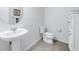 Bright powder room features tile flooring, vanity and storage cabinet at 6216 Kevesta Ave, Palmetto, FL 34221