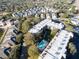 Aerial view of the condominium, surrounded by trees and adjacent to a residential neighborhood and pool at 90 S Highland Ave # 423, Tarpon Springs, FL 34689