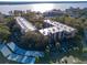 Aerial view of the community featuring well-manicured lawns, a waterfront view, and covered parking at 90 S Highland Ave # 423, Tarpon Springs, FL 34689