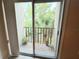 A small balcony with plants and a view of palm trees and other lush greenery at 90 S Highland Ave # 423, Tarpon Springs, FL 34689