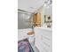 Bright bathroom featuring a shower-tub combo, white vanity, and an elegant storage shelf at 90 S Highland Ave # 423, Tarpon Springs, FL 34689