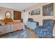 Comfortable bedroom featuring warm tones, a large window, and a floral upholstered chair at 90 S Highland Ave # 423, Tarpon Springs, FL 34689