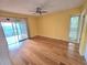 Bedroom with wood floors, ceiling fan, and sliding glass doors that lead to a balcony at 90 S Highland Ave # 423, Tarpon Springs, FL 34689