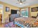 Bright bedroom featuring a colorful quilt, a ceiling fan, and a sliding glass door to a balcony at 90 S Highland Ave # 423, Tarpon Springs, FL 34689