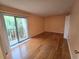 Bedroom featuring hardwood floors and sliding glass doors leading to balcony at 90 S Highland Ave # 423, Tarpon Springs, FL 34689