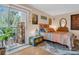 Charming bedroom featuring balcony access, a colorful antique chest, and modern eclectic decor at 90 S Highland Ave # 423, Tarpon Springs, FL 34689