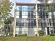 Multi-story condo building featuring large windows and private balconies overlooking the community at 90 S Highland Ave # 423, Tarpon Springs, FL 34689