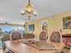 Charming dining room boasting hardwood floors, a tropical light fixture, and beautiful decor at 90 S Highland Ave # 423, Tarpon Springs, FL 34689