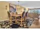 Dining room leading into the living room, featuring hardwood floors, and ornate chairs at 90 S Highland Ave # 423, Tarpon Springs, FL 34689