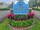 The community entrance sign for Lake Tarpon Sail & Tennis Club is surrounded by colorful landscaping at 90 S Highland Ave # 423, Tarpon Springs, FL 34689