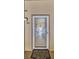 Exterior shot of the front door of unit 423 with a screen door and an ornate welcome mat at 90 S Highland Ave # 423, Tarpon Springs, FL 34689