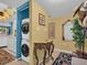 Hallway featuring a side-by-side washer and dryer and decorated with an elegant table and mirror at 90 S Highland Ave # 423, Tarpon Springs, FL 34689