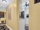 Hallway leading to an eat-in kitchen, with stainless steel appliances and white cabinets at 90 S Highland Ave # 423, Tarpon Springs, FL 34689