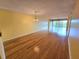 Spacious living room with gleaming hardwood floors and a sliding glass door to the outside at 90 S Highland Ave # 423, Tarpon Springs, FL 34689