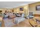 Cozy living room with comfortable seating, unique decor, and hardwood floors at 90 S Highland Ave # 423, Tarpon Springs, FL 34689