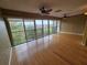Bright and airy living room with wood floors, fan, and large windows offering a scenic view at 90 S Highland Ave # 423, Tarpon Springs, FL 34689