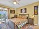 A cozy main bedroom featuring warm tones, vibrant decor, and access to the balcony at 90 S Highland Ave # 423, Tarpon Springs, FL 34689