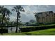 Tennis courts surrounded by lush landscaping and tall palm trees in a well-maintained community at 90 S Highland Ave # 423, Tarpon Springs, FL 34689
