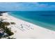 Aerial view of a beautiful beach with blue water and many beachgoers at 911 Boca Ciega Isle Dr, St Pete Beach, FL 33706