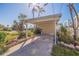 Carport with lush tropical landscaping and a brick-lined garden at 911 Boca Ciega Isle Dr, St Pete Beach, FL 33706