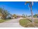 Charming single-story home with palm trees and a circular driveway at 911 Boca Ciega Isle Dr, St Pete Beach, FL 33706