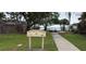 View of Boca Ciega Isle Mini Park with lush grass and trees near the water at 911 Boca Ciega Isle Dr, St Pete Beach, FL 33706