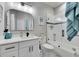 Fresh bathroom featuring a white vanity, decorative mirror, and tiled shower with a glass door at 204 Latitude Pl, Apollo Beach, FL 33572