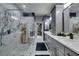 Elegant primary bathroom with a large glass shower, double vanity, and walk-in closet at 204 Latitude Pl, Apollo Beach, FL 33572