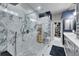 Modern bathroom featuring a marble shower, dual vanity, and a walk-in closet at 204 Latitude Pl, Apollo Beach, FL 33572