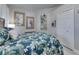 Comfortable bedroom showing a bed with blue floral bedding, artwork, and a closet at 204 Latitude Pl, Apollo Beach, FL 33572