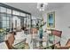 Bright dining room with a glass table, seating for six, and elegant decor at 204 Latitude Pl, Apollo Beach, FL 33572