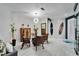 Bright dining room with a glass table, unique light fixture, and modern decor at 204 Latitude Pl, Apollo Beach, FL 33572