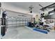 Organized garage with ample space for storage, featuring an elliptical machine and a storage cabinet system at 204 Latitude Pl, Apollo Beach, FL 33572