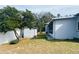 Large backyard featuring a storage shed and screened-in lanai on the residence at 4209 Amber Ridge Ln, Valrico, FL 33594