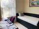 Office/bedroom with a desk, chair, and daybed by a bright window at 4209 Amber Ridge Ln, Valrico, FL 33594