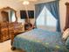Bright bedroom featuring wooden furniture, window and bedding at 4209 Amber Ridge Ln, Valrico, FL 33594