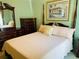 Bedroom featuring a four-poster bed, dark wooden furniture, and artwork at 4209 Amber Ridge Ln, Valrico, FL 33594