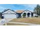 Charming single-story home featuring a two-car garage, neutral stucco exterior and well-maintained lawn at 4209 Amber Ridge Ln, Valrico, FL 33594
