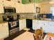 Modern kitchen featuring stainless steel appliances, granite countertops, and tile flooring at 4209 Amber Ridge Ln, Valrico, FL 33594
