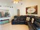 Spacious living room boasts tile floors and a large leather couch at 4209 Amber Ridge Ln, Valrico, FL 33594