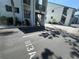 Condo building with staircase, gravel landscaping, assigned parking space, and blue sky and sunny weather at 813 Bahia Del Sol Dr # 33, Ruskin, FL 33570