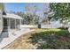 Large fenced backyard with a screened-in porch, fire pit, and storage shed at 2951 Bay View Dr, Safety Harbor, FL 34695