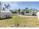 Well-maintained backyard with a storage shed, grilling area, and a white vinyl fence at 2951 Bay View Dr, Safety Harbor, FL 34695