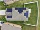 Aerial view of a home with solar panels on the roof, a manicured lawn, and a fenced backyard at 11127 Hudson Hills Ln, Riverview, FL 33579